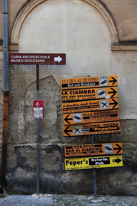 Signs for places of interest in the old town of Moreale, Sicily, Italy