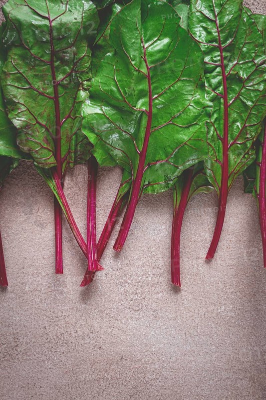 Fresh, green leaves, stem with beet leaves, on the table, top view, rustic, no people