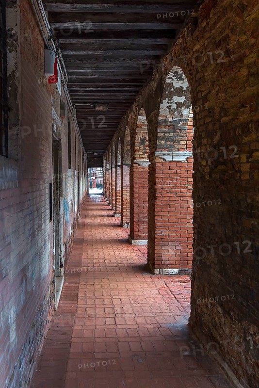 Arcade with brick columns in the old town, Venice, Veneto, Italy