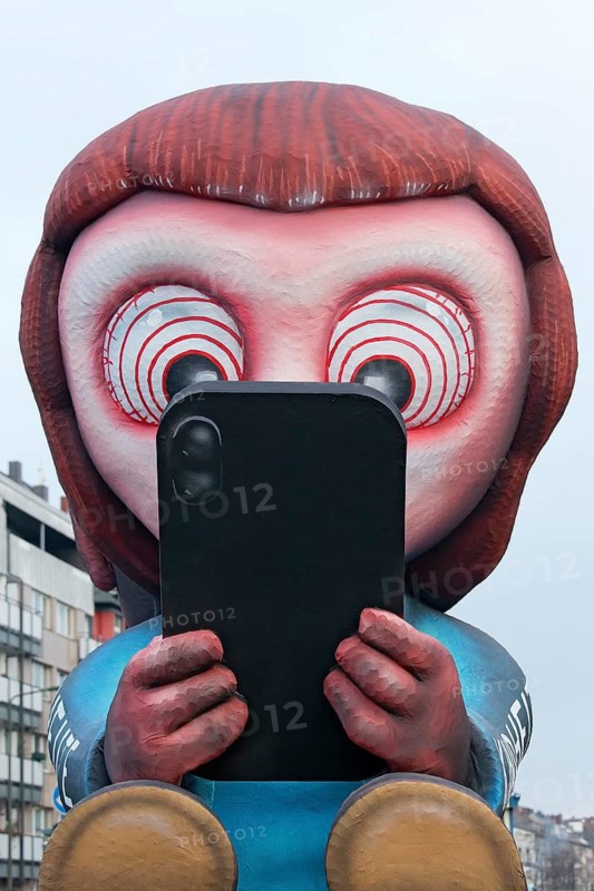 Young person staring at cell phone, social media addiction, social media ban, theme car by wagon maker Jacques Tilly, Düsseldorf Rose Monday train, Düsseldorf, North Rhine-Westphalia, Germany