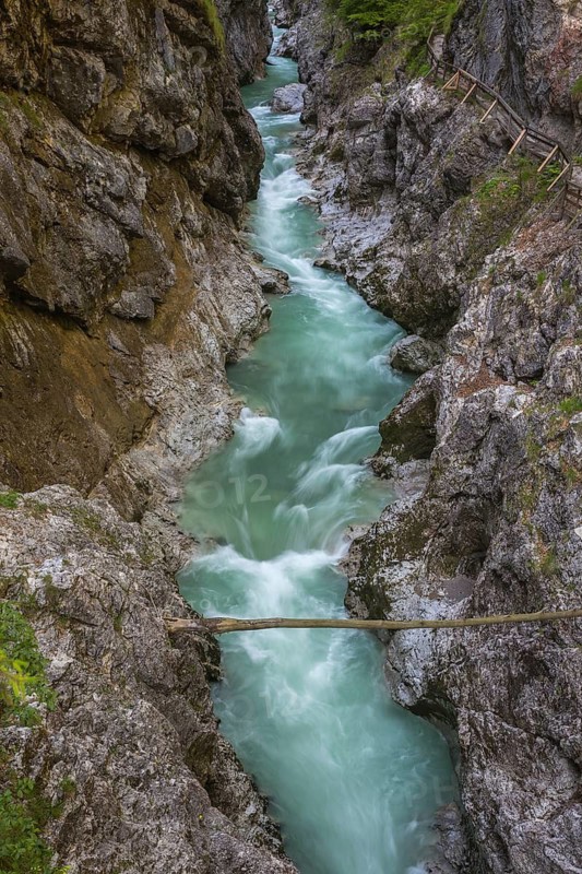 The Lammer creek is flowing fast through the Lammerklamm on a sunny hiking day