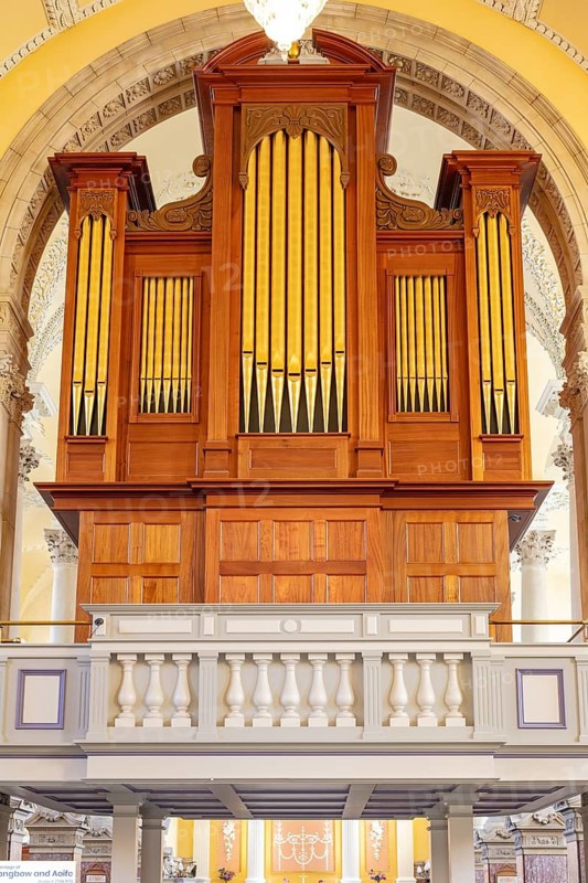 Large wooden organ with golden pipes in a church, Waterford