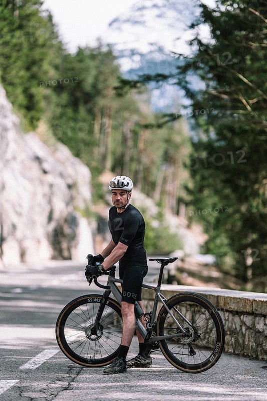 Road bike rider in spring between Lechtal and Tannheimer Tal in front of picturesque scenery of the Alps, Tyrol, Austria