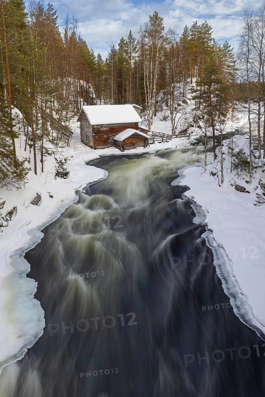 Old wooden Myllykoski water mill along the river Kitkajoki in winter, Oulanka National Park, Northern Ostrobothnia, Norra Österbotten, Finland