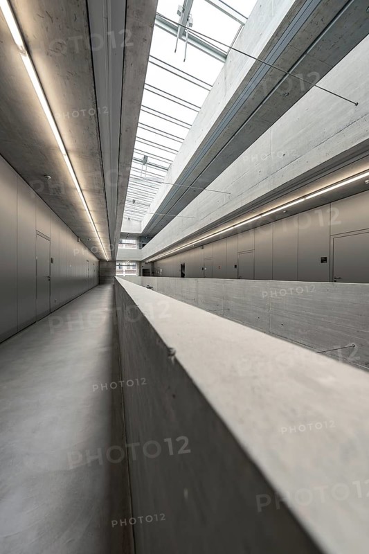 Long and slender corridor in minimalist concrete style, flooded with natural light, University of Stuttgart, Germany