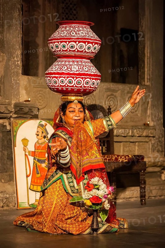 UDAIPUR, INDIA, NOVEMBER 24: Bhavai performance, famous folk dance of Rajasthan state of India. Performer balances number of earthen pots as she dance. November 24, 2012 in Udaipur, Rajasthan, India