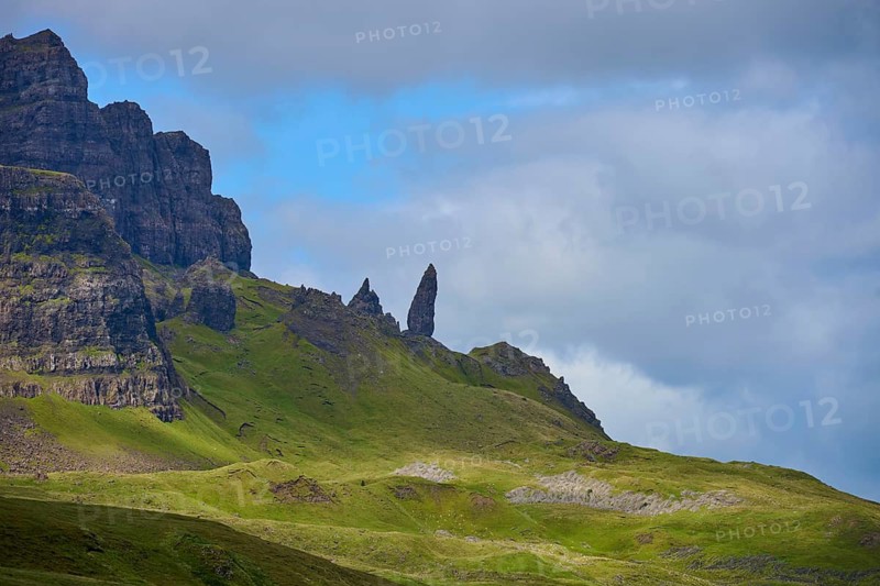 Dramatic mountain landscape with distinctive rocks under a partly cloudy sky, Old Man of Storr, Portree, Isle of Skye, Scotland, United Kingdom, Great Britain