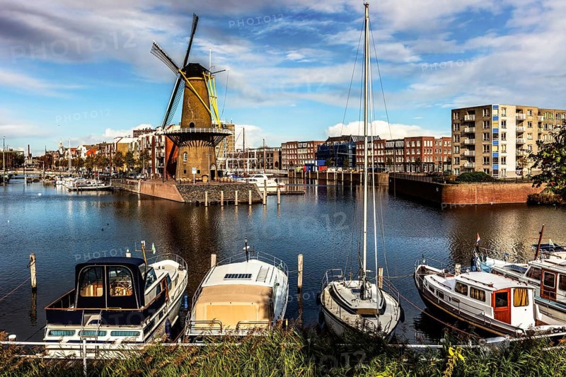 Windmill De Distilleerketel, flour mill in the historic port of Delfshaven, place from which the Pilgrim Fathers set off for America in 1620, city panorama, Rotterdam, Netherlands