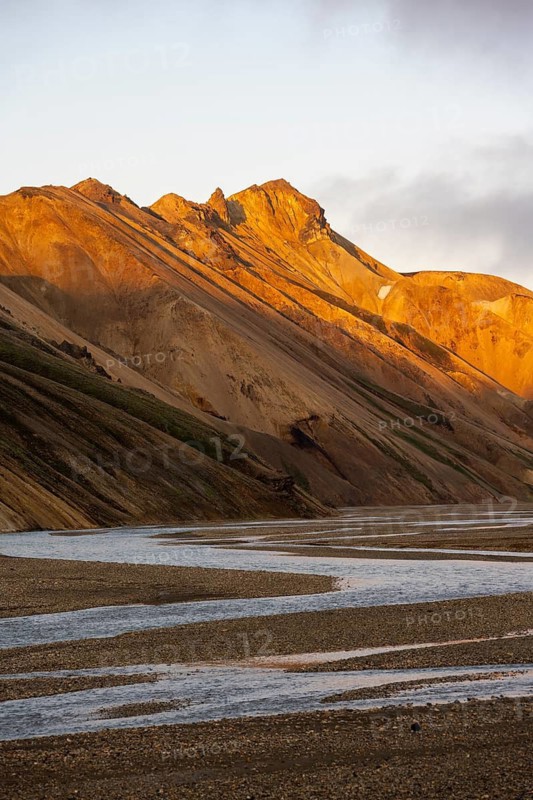 Rhyolite mountains and river Jökulgilskvísl, Landscape at Landmannalaugar, Dramatic volcanic landscape at sunset, Colourful erosion landscape with mountains, Landmannalaugar, Fjallabak Nature Reserve, Suðurland, Iceland
