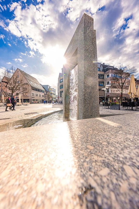 Sunny day with an architecturally interesting fountain in the city center, Nagold, Calw district, Germany