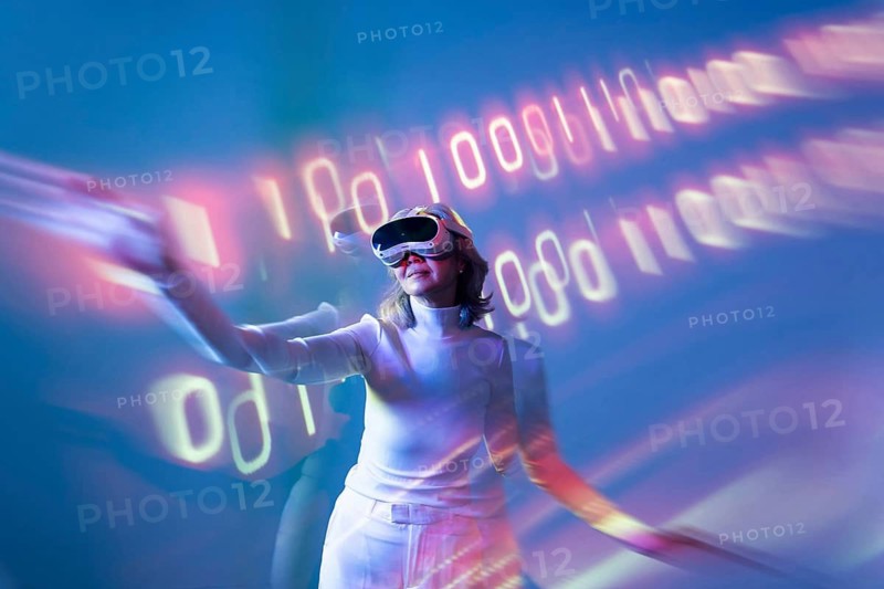 An elderly Asian woman experiences the metaverse using virtual reality technology, engaging with digital environments while wearing a VR headset in a futuristic setting