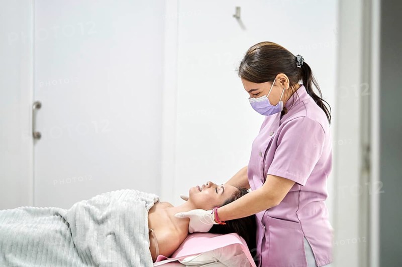 A skilled therapist provides a soothing massage to a client in a modern beauty salon, promoting relaxation and enhancing skin health. The environment is calm and tranquil, ideal for self-care