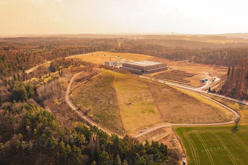Elevation next to an industrial site, surrounded by roads and forest with a wide view, old deposit in front of PV Bau, Lindenrain, Calw, Germany