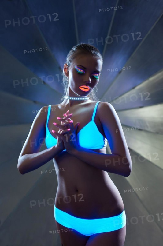 Girl with ultraviolet make-up disco dance in dark