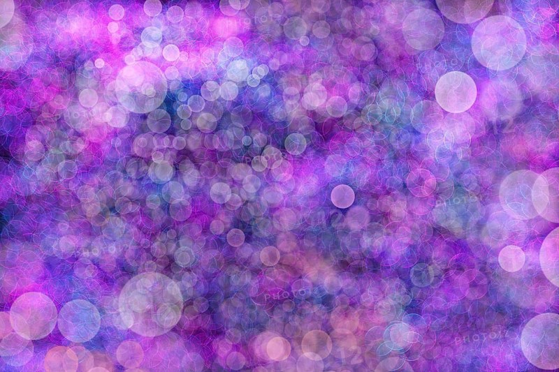 A vibrant abstract background featuring a dreamy blend of purple and blue hues with bokeh light effects. Perfect for creative design projects needing an ethereal touch