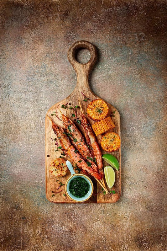Langoustines on skewers, shrimp kebab, with fried corn, spices and herbs, homemade, no people