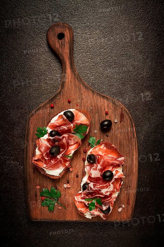 Sandwich with cream cheese, prosciutto with olives, breakfast