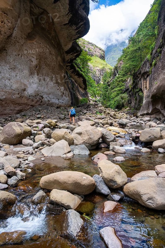 Female hiker in the Tugela Gorge or Tugela Gorge in the riverbed, Drakensberg National Park, KwaZulu Natal, South Africa