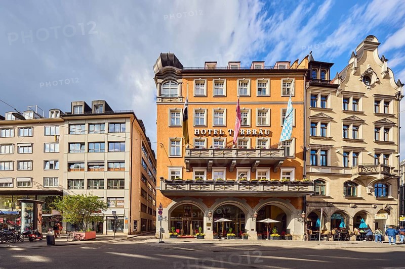 Hotel Torbräu, historic commercial building, German Renaissance style, balcony, dormers, façade with windows, outdoor area of a restaurant, Schapeau and Weiberwirtschaft, roads, trees, blue sky, cumulus clouds, Pflugstraße confluence with Tal, Munich, state capital, district-free city, Bavaria, Germany