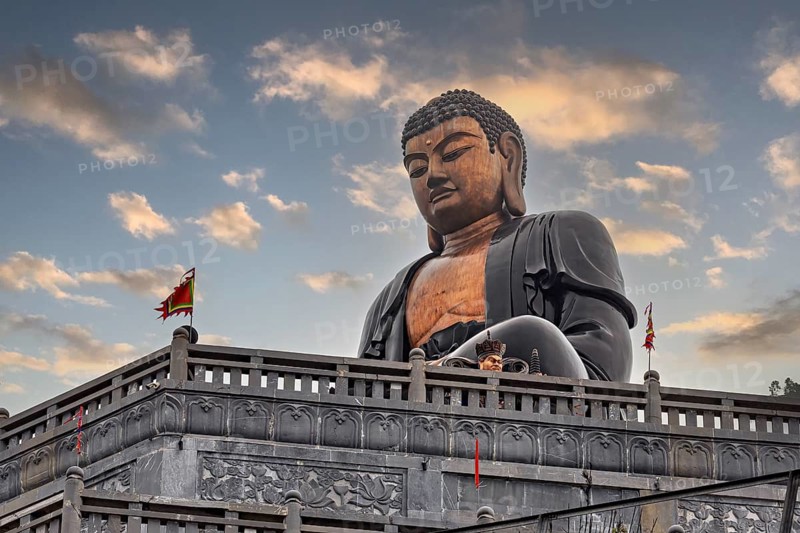 Large Buddha statue in a temple against a cloudy sky, Large Buddha statue at Fansipan in the mountains near Sa Pa in Vietnam