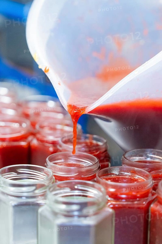 Jam is filled into jars while red juice drips, jam production, Haselstaller Hof, Wildberg Gültlingen, district of Calw, Black Forest, Germany
