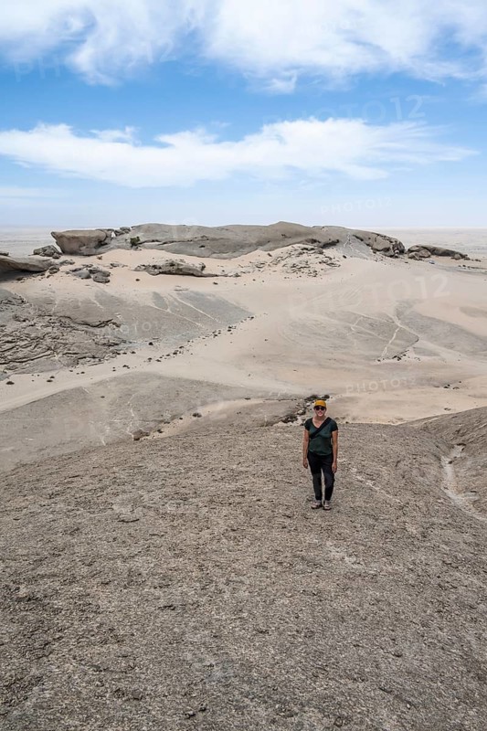 Tourist at Vogelfederberg, granite rocks, Namib Naukluft Park, Namibia