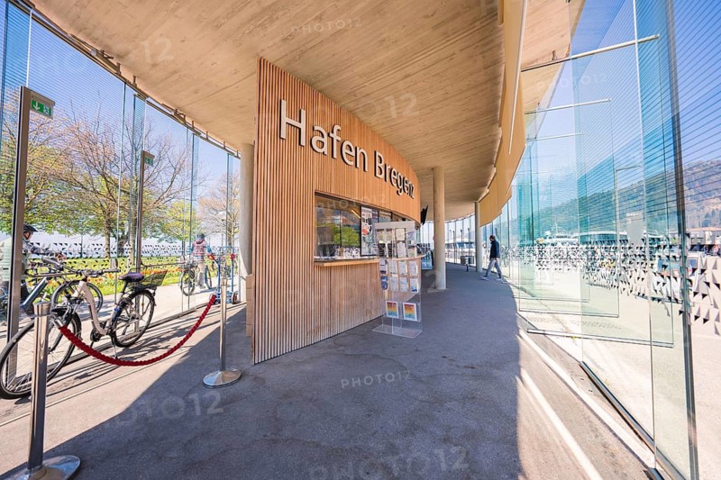 Modern harbour with glass paneling and bicycles in sunny weather, Bregenz, Vorarlberg, Austria