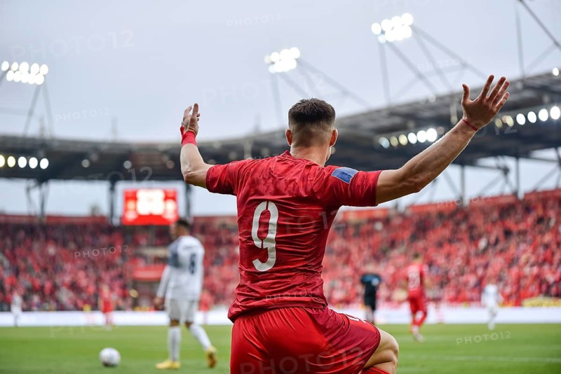Footballer during soccer match. A gesture with raised hands in Lodz, Poland