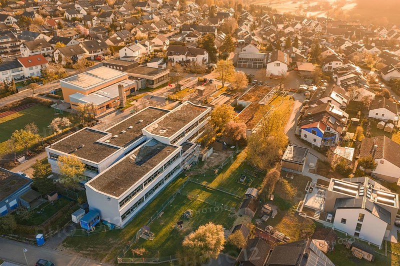 School and residential building in autumn village landscape with gardens, Schlehengäuschule, Gechingen, Hecken and Gäu region, Calw district, Germany