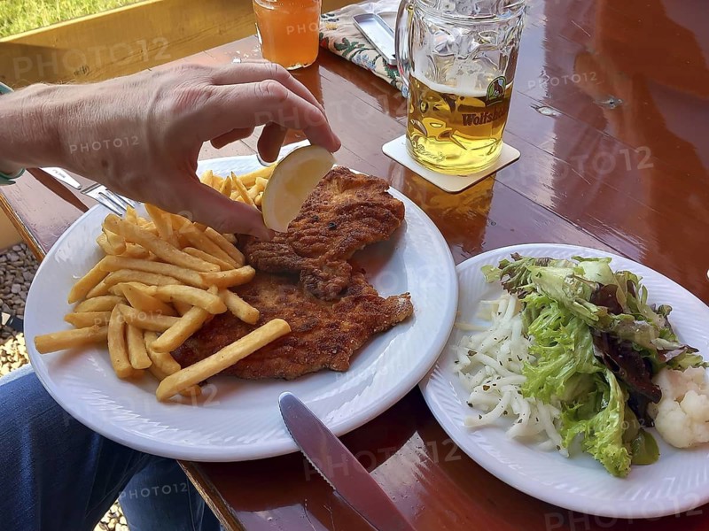 Wiener schnitzel served with French fries and salad in a beer garden, Bavaria, Germany