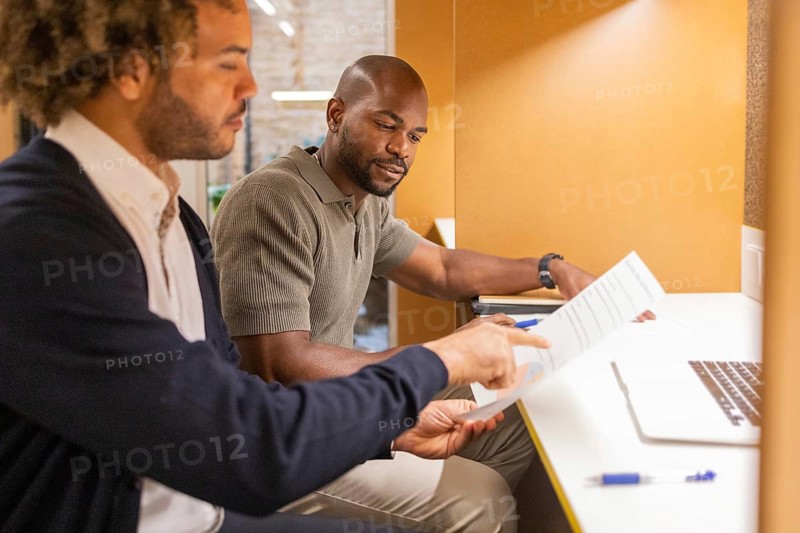 Professionals collaborate in a modern coworking space in Barcelona, fostering innovation and teamwork. The vibrant workspace encourages productivity and creative synergy among colleagues