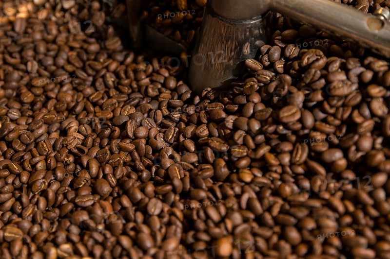 Coffee is roasted by hand in a small drum roaster with lots of experience, where the hot freshly roasted coffee beans cool down using air in a sieve, Kaffeerösterei Müller, Wildenhain, Großenhain, Saxony, Germany