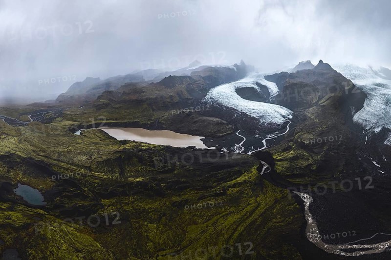 Atmospheric view of Vatnajökull Glacier, winding through the rugged landscape of Vatnajökull National Park, Iceland, under a moody sky