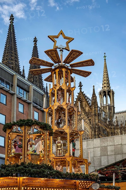 Christmas pyramid at Christmas market Adventsdorf am Kölner Dom at dusk, Cologne, North Rhine-Westphalia, Germany