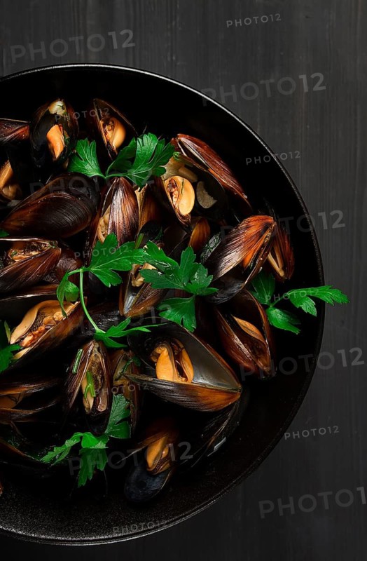 Fresh, Boiled mussels, Black Sea, with parsley and lemon, on a wooden table, no people