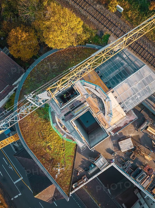 Bird's eye view of a construction site with crane and adjacent railway line, ZOB Calw reconstruction for Hermann Hessebahn, Calw, Black Forest, Germany