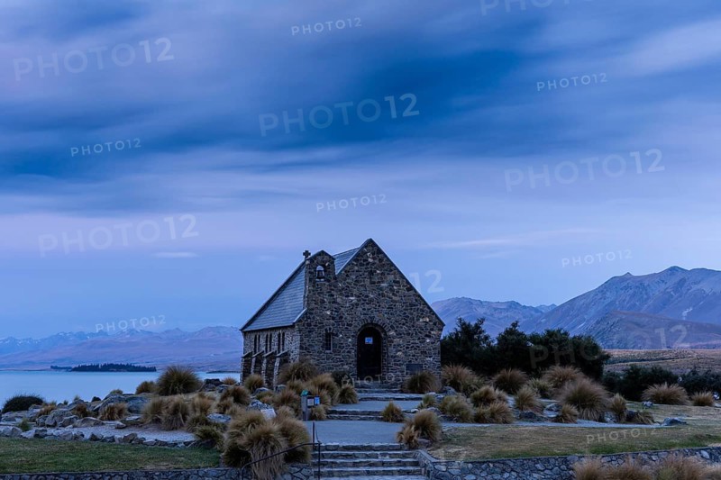 The small church The Church of the Good Shepherd on Lake Tekapo with a cloudy sky at sunset. long exposure. Canterbury, South Island, New Zealand