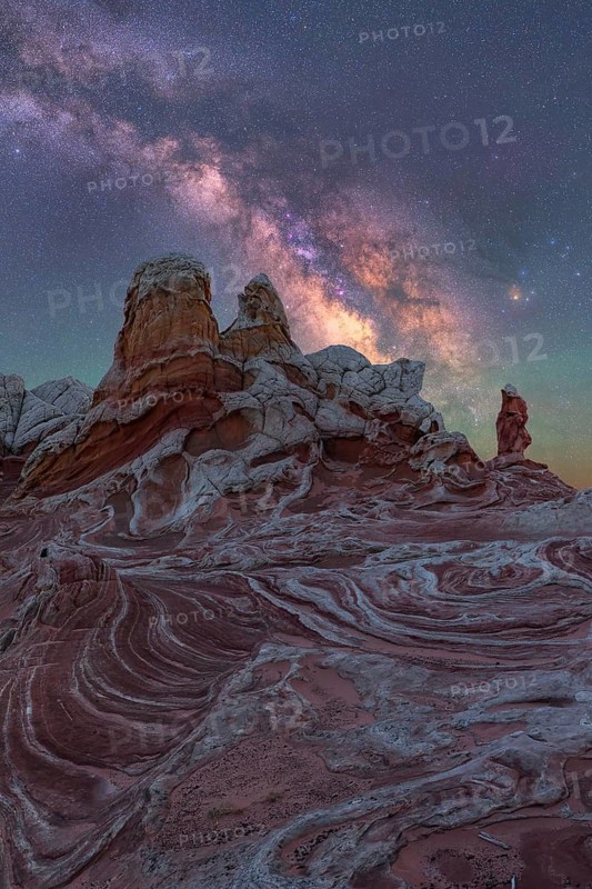 A stunning nightscape of the Milky Way illuminating the unique rock formations of White Pocket, Arizona, USA. The desert landscape is beautifully captured under a starry sky