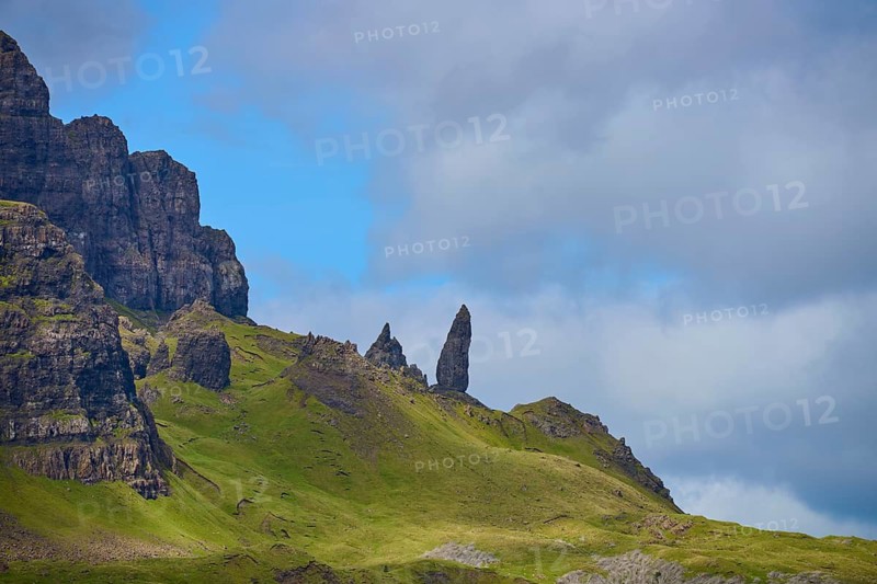 Green hills with jagged rocks under a cloudy sky, Old Man of Storr, Portree, Isle of Skye, Scotland, United Kingdom, United Kingdom