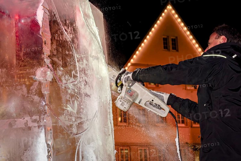 An ice sculpture is being created: ice carving street action as part of the long shopping night in the city center of Reutlingen, Baden-Württemberg, Germany, for editorial use only