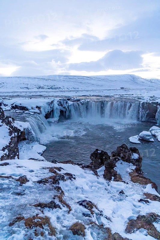 Amazing scenery of frozen Godafoss waterfall at sunset in winter, Iceland