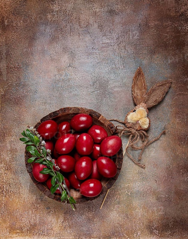 Painted eggs in a wooden bowl, red, painted madder dye, powder from the roots of endro, with onion husks, top view, Easter, Georgia