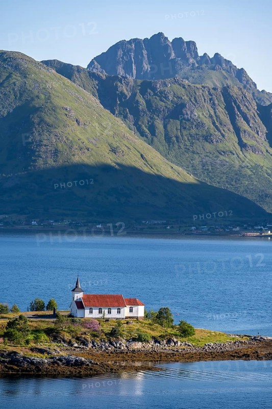 Small church Sildpollnes Kirke at the fjord Austnesfjorden, idyllic Norwegian fjord landscape, Sildpollen, Nordland, Norway