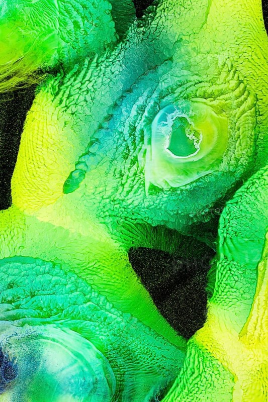 A vibrant abstract image featuring swirling greens and yellows with galaxy, liquids patterns. The textured surface offers a sense of depth and dynamic movement