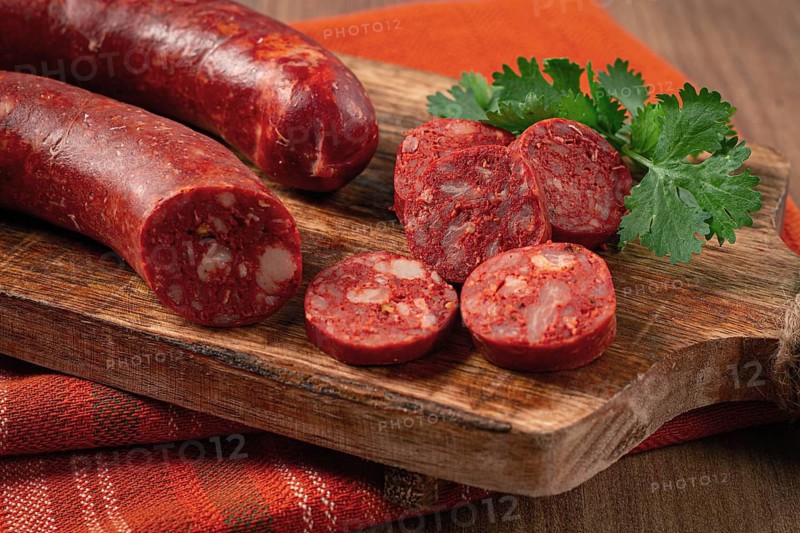 Spicy Chorizo sausage, on a cutting board, on a wooden table