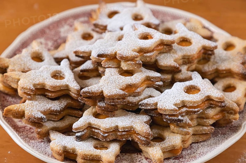 Stacks of Easter bunny shaped cookies dusted with powdered sugar, served on a plate