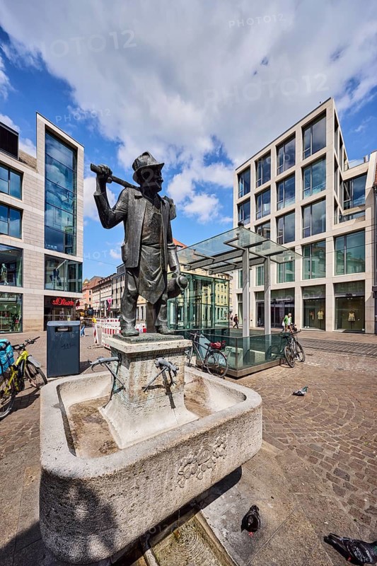 Häckerbrunnen, fountain with bronze sculpture, sculptor Richard Rother, general architecture, commercial building, pedestrian zone, bicycle, blue sky, cumulus clouds, intersection of Schönbornstraße street with marketplace square, Würzburg, Lower Franconia, district-free city, Bavaria, Germany