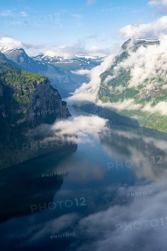 Atmospheric clouds over the fjord in the morning light, view of Geirangerfjord, at Ørnesvingen viewpoint, near Geiranger, Møre og Romsdal, Norway