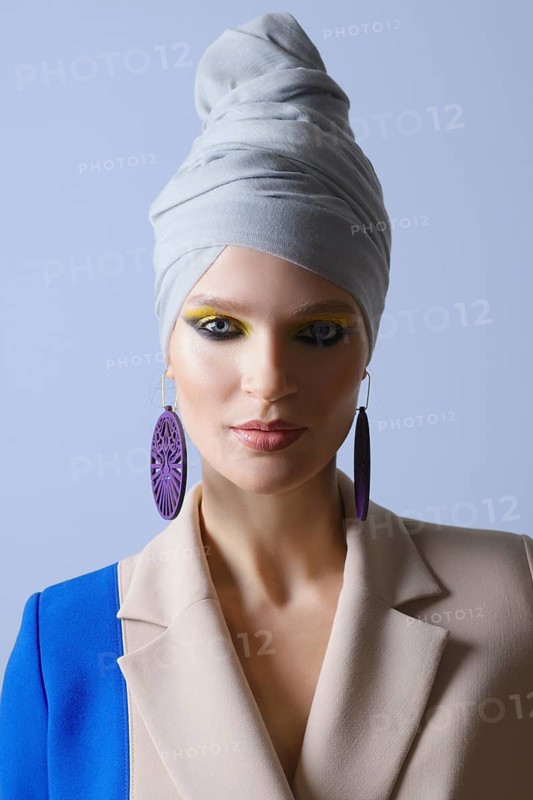 Beautiful lady in double color suit and turban on head