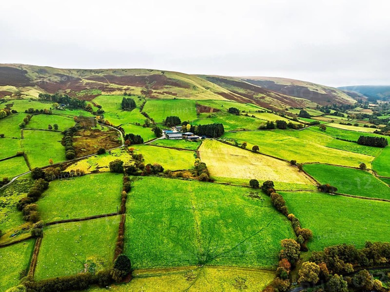 Autumn colours of Farms over River Wye and Road A470 from a drone, Llanidloes, Powys, Montgomeryshire, Wales, UK
